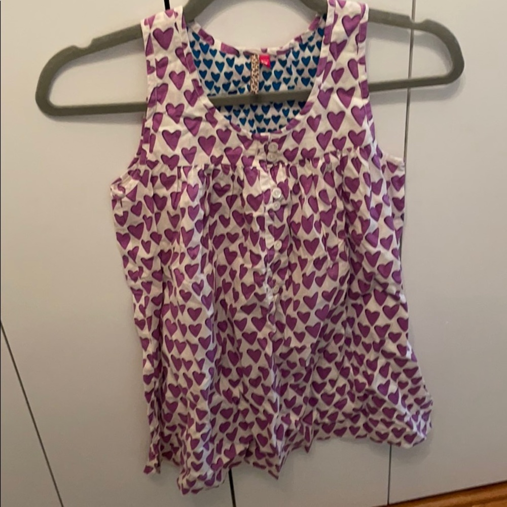 A super cute girls white and purple heart blouse